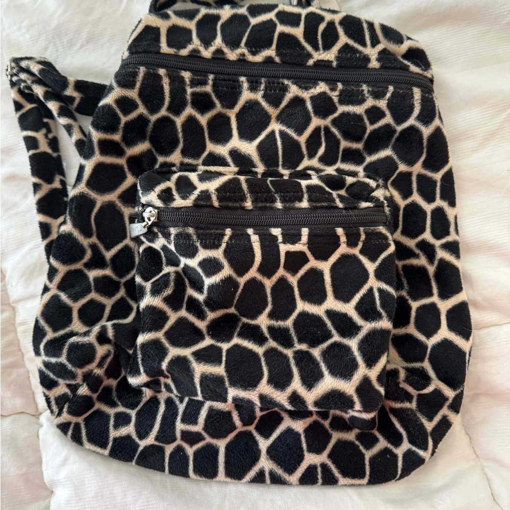 Backpack soft animal print with adjustable straps two zipper compartments.
